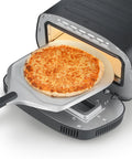 Sliding a pizza into the CASO PizzaChef 430°