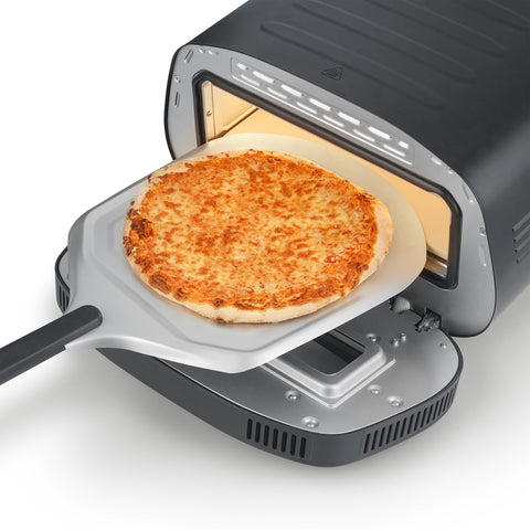 Sliding a pizza into the CASO PizzaChef 430°